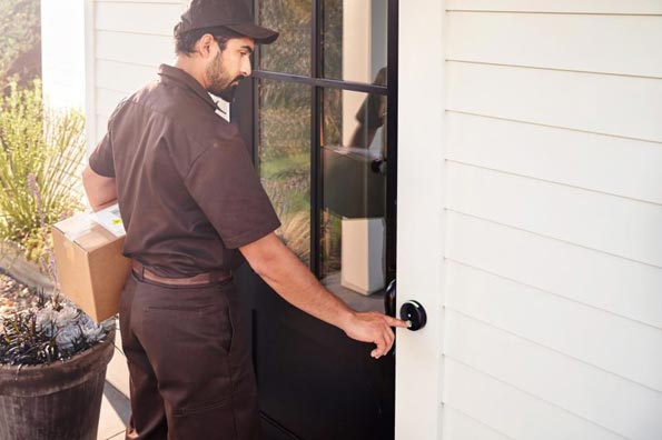 delivery man with package ringing skybell