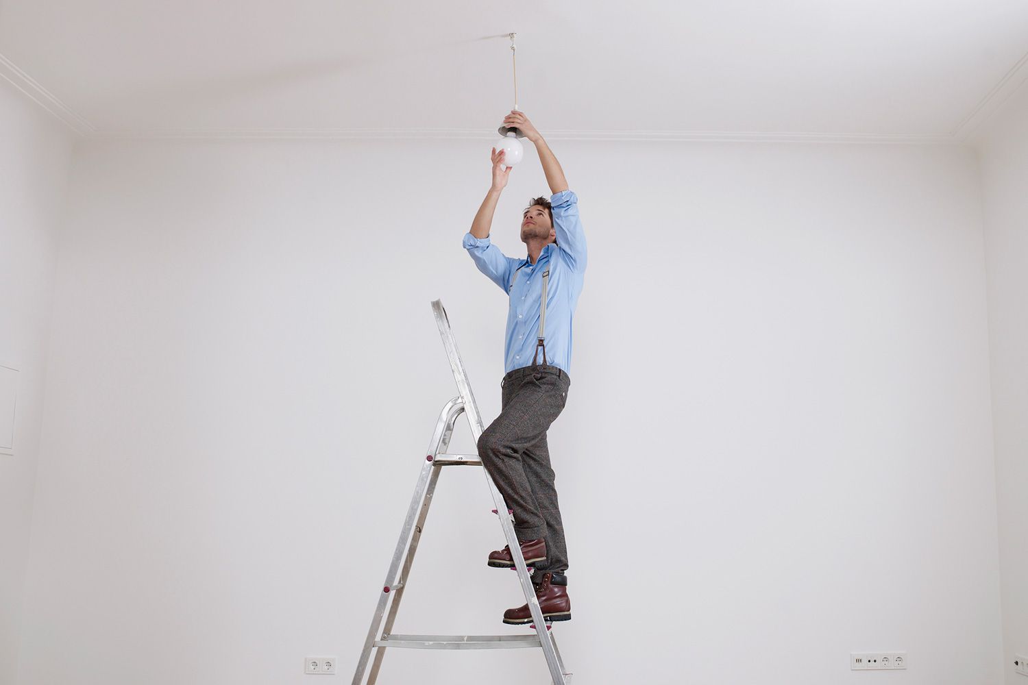 man-climbing-ladder-fixing-light